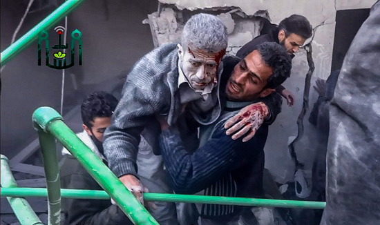 A man is carried out of the rubble after an air strike hit Douma, Syria, January 8, 2014. (Freedom House/Flickr)