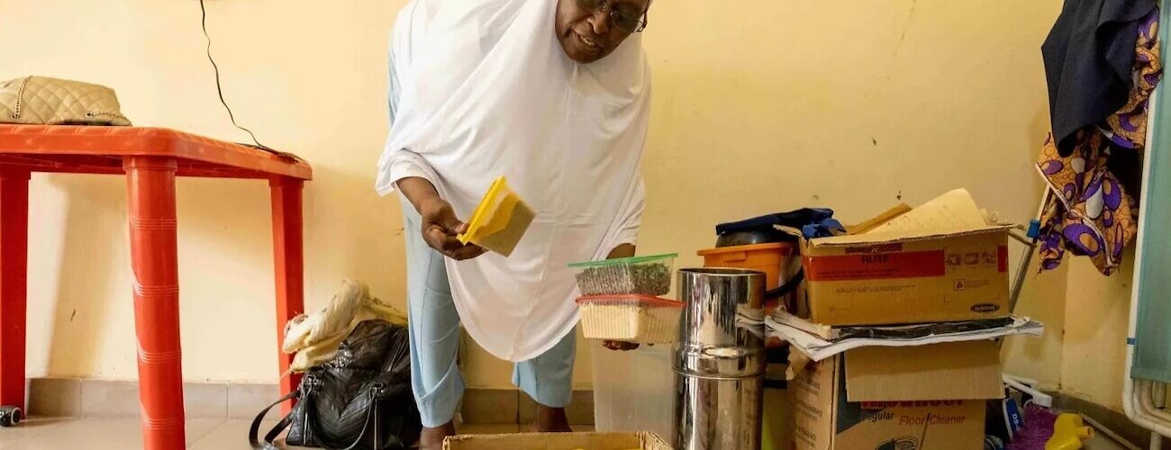A health worker at a primary healthcare center on the outskirts of Maiduguri shows the food grains she distributes