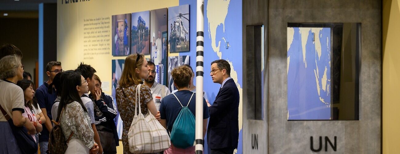 A view of visitors at the peace and security exhibit during a guided tour of the UN headquarters