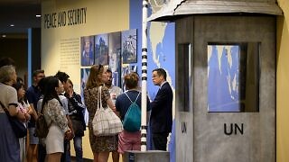 A view of visitors at the peace and security exhibit during a guided tour of the UN headquarters